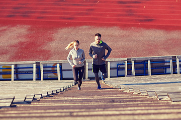 Image showing couple running upstairs on stadium