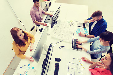 Image showing creative team with computers, blueprint at office