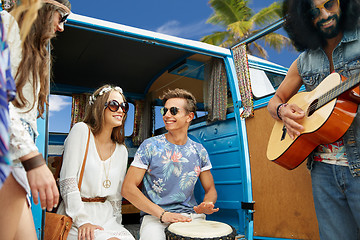 Image showing hippie friends playing music over minivan on beach