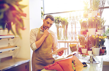 Image showing man with tablet pc computer at flower shop