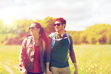 Image showing happy couple with backpacks hiking outdoors