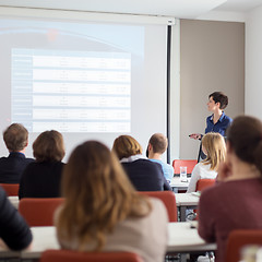 Image showing Woman giving presentation in lecture hall at university.