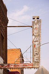 Image showing Old Vertical composition metal neon theatre sign against blue sk