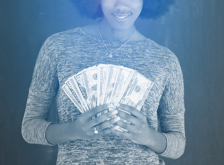 Image showing black woman holding money on gray background