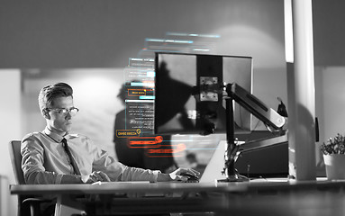 Image showing man working on computer in dark office