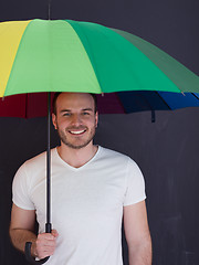 Image showing handsome man with a colorful umbrella