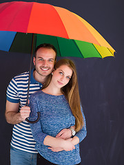 Image showing handsome couple with a colorful umbrella