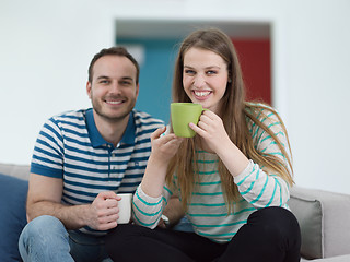 Image showing young handsome couple enjoying morning coffee