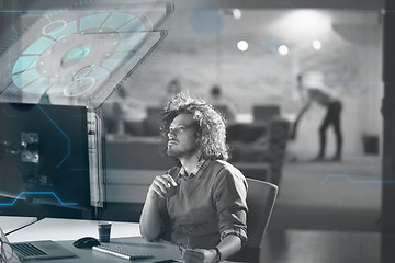 Image showing man working on computer in dark office