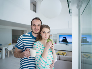 Image showing young handsome couple enjoying morning coffee