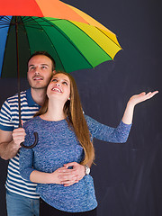 Image showing handsome couple with a colorful umbrella