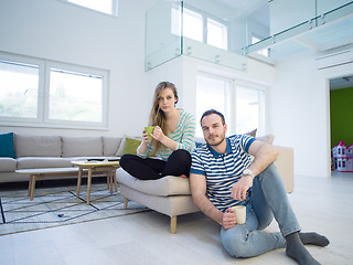 Image showing young handsome couple enjoying morning coffee