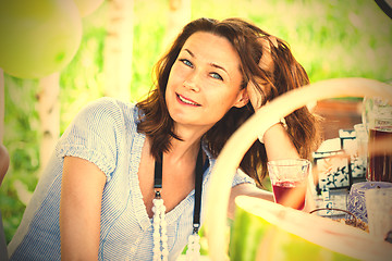 Image showing smiling beautiful woman at a table at a party