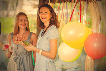 Image showing Two beautiful cheerful women at a picnic