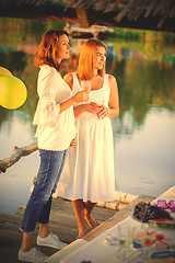 Image showing two young beautiful women at a party near the water