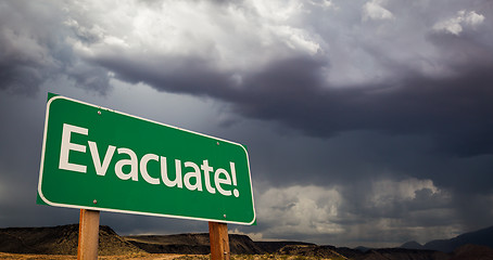 Image showing Evacuate Green Road Sign and Stormy Clouds