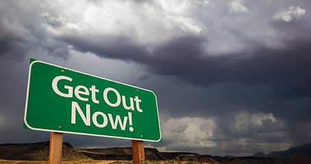 Image showing Get Out Green Road Sign and Stormy Clouds