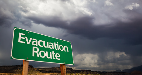 Image showing Evacuation Route Green Road Sign and Stormy Clouds