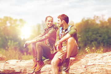 Image showing smiling couple with backpacks in nature