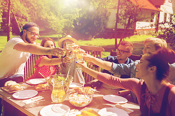 Image showing happy friends having dinner at summer garden party