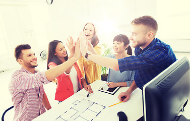 Image showing creative team making high five at office