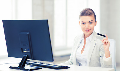 Image showing businesswoman with computer using credit card