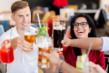 Image showing friends clinking glasses with drinks at restaurant