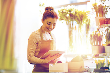 Image showing woman with tablet pc computer at flower shop