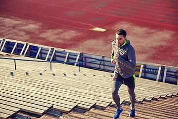 Image showing young man running upstairs on stadium