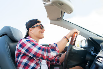 Image showing happy young man driving convertible car