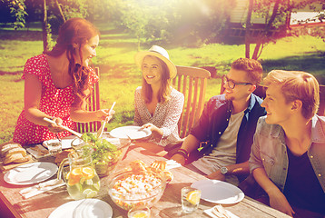 Image showing happy friends having dinner at summer garden party