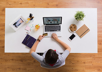 Image showing woman with laptop and credit card at table