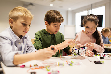 Image showing happy children building robots at robotics school