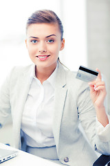 Image showing businesswoman with laptop showing credit card