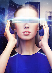 Image showing woman in virtual reality glasses over space city