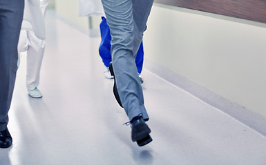 Image showing close up of medics or doctors running at hospital