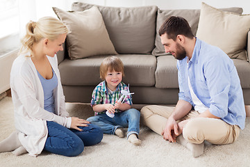 Image showing happy family playing with toy wind turbine