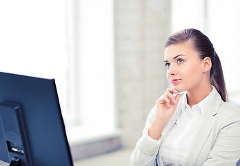 Image showing pensive woman in office