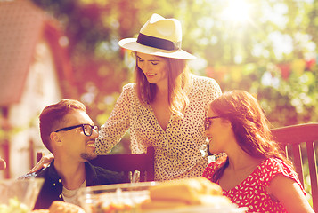 Image showing happy friends having dinner at summer garden party