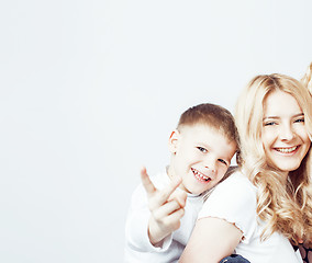 Image showing young modern blond curly mother with cute son together happy smiling family posing cheerful on white background, lifestyle people concept, sister and brother friends 