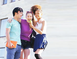 Image showing cute group of teenages at the building of university with books huggings, back to school