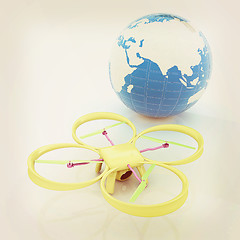 Image showing Quadrocopter Drone with Earth Globe and remote controller on a w