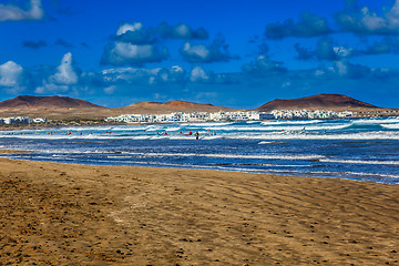 Image showing Surfers and kiters in the water on Famara beach, Lanzarote