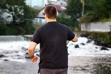 Image showing Young man with fishing rod