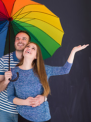 Image showing handsome couple with a colorful umbrella