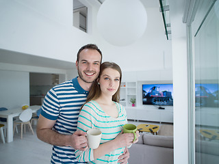 Image showing young handsome couple enjoying morning coffee
