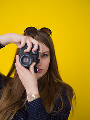 Image showing young girl taking photo on a retro camera