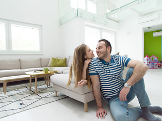 Image showing young handsome couple hugging on the sofa