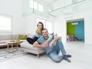 Image showing young handsome couple enjoying morning coffee