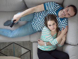 Image showing young handsome couple hugging on the sofa